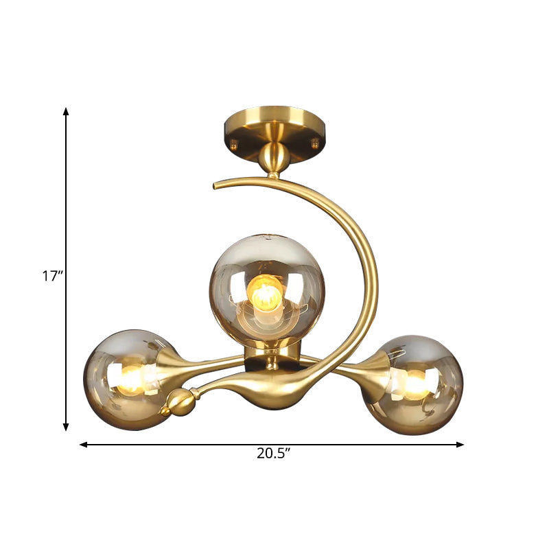 Burst Semi Flush Chandelier Postmodern Amber Glass Orb 3/5 Heads Brass Ceiling Mounted Light with Curved Arm over Table Clearhalo 'Ceiling Lights' 'Close To Ceiling Lights' 'Close to ceiling' 'Glass shade' 'Glass' 'Semi-flushmount' Lighting' 1454846