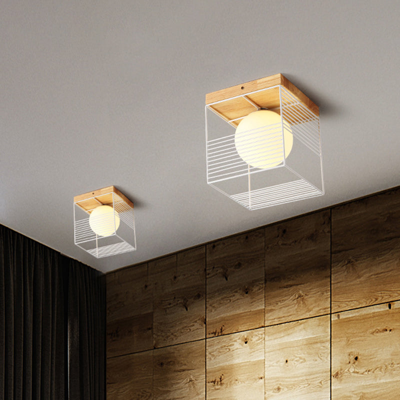 Black/White Cubic Cage Small Ceiling Lamp Nordic 1 Head Iron Flush Light Fixture with Inner Ball Glass Shade and Wood Canopy White Clearhalo 'Ceiling Lights' 'Close To Ceiling Lights' 'Close to ceiling' 'Flush mount' Lighting' 1475100