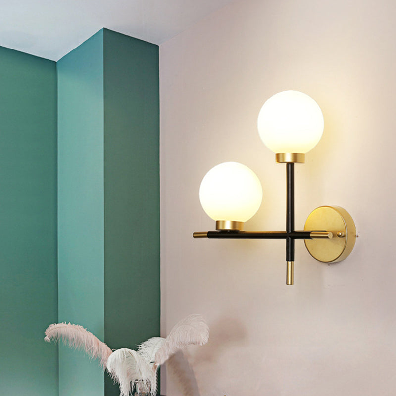 2-Bulb Milky Glass Sconce Light Fixture Modern Black Double Globe Living Room Wall Lamp with Cross Design White Right Clearhalo 'Cast Iron' 'Glass' 'Industrial' 'Modern wall lights' 'Modern' 'Tiffany' 'Traditional wall lights' 'Wall Lamps & Sconces' 'Wall Lights' Lighting' 161509