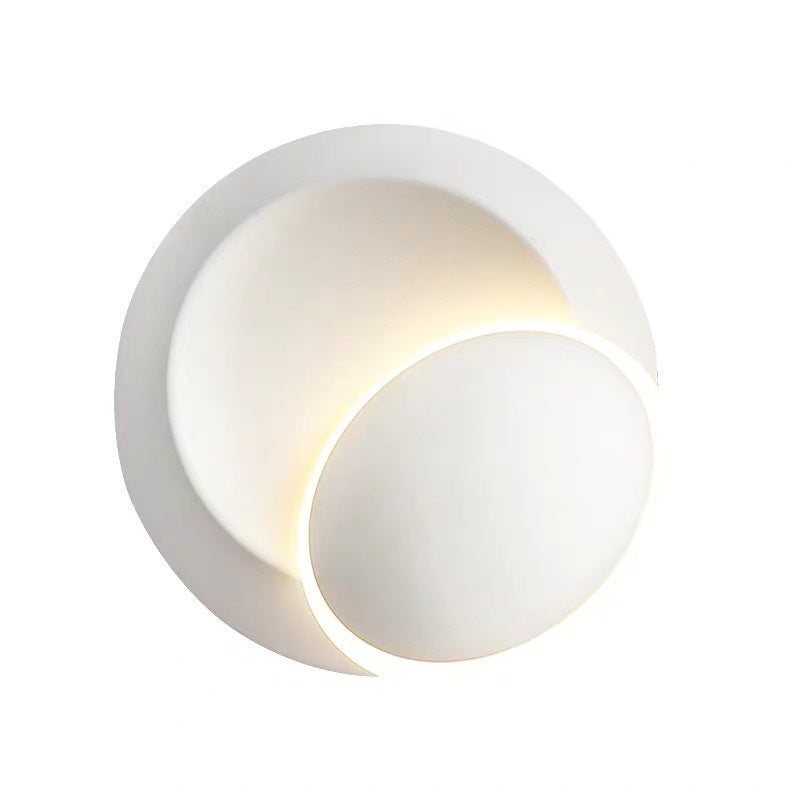 Black/White Rotating Ellipse Wall Lamp Modern Novelty Iron LED Surface Wall Sconce with Simulated Eclipse Design Clearhalo 'Cast Iron' 'Glass' 'Industrial' 'Modern wall lights' 'Modern' 'Tiffany' 'Traditional wall lights' 'Wall Lamps & Sconces' 'Wall Lights' Lighting' 1788989