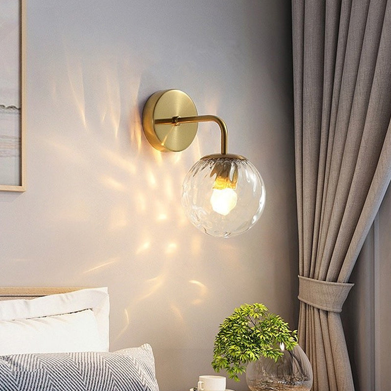 Ball Shaped Wall Lamp Minimalist Clear Rippling Glass 1-Light Bedroom Wall Mounted Lighting with Bent Arm in Black/Gold Gold Clearhalo 'Cast Iron' 'Glass' 'Industrial' 'Modern wall lights' 'Modern' 'Tiffany' 'Traditional wall lights' 'Wall Lamps & Sconces' 'Wall Lights' Lighting' 1936626