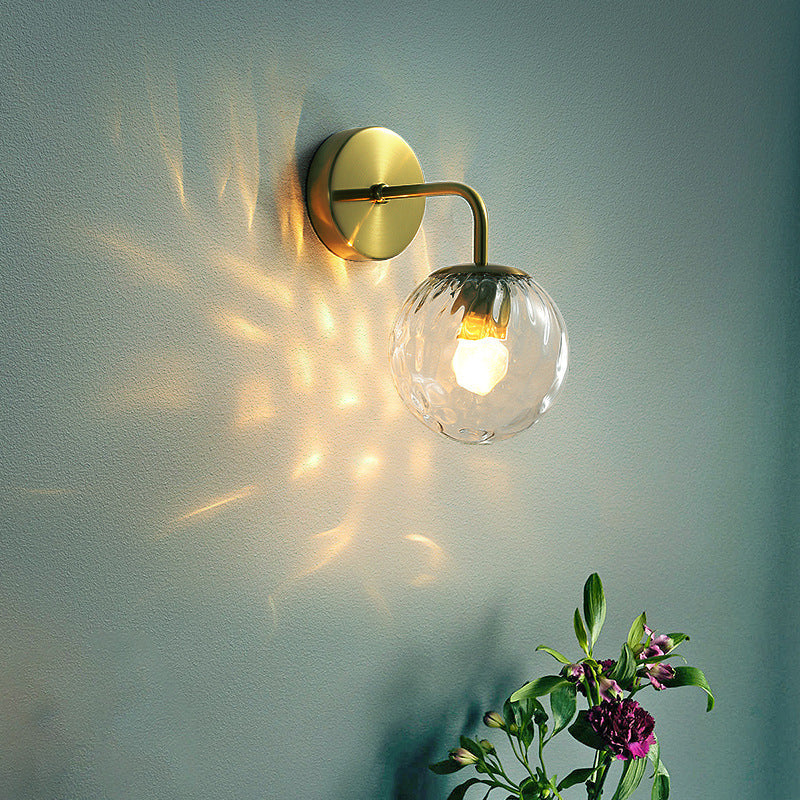 Ball Shaped Wall Lamp Minimalist Clear Rippling Glass 1-Light Bedroom Wall Mounted Lighting with Bent Arm in Black/Gold Clearhalo 'Cast Iron' 'Glass' 'Industrial' 'Modern wall lights' 'Modern' 'Tiffany' 'Traditional wall lights' 'Wall Lamps & Sconces' 'Wall Lights' Lighting' 1936627
