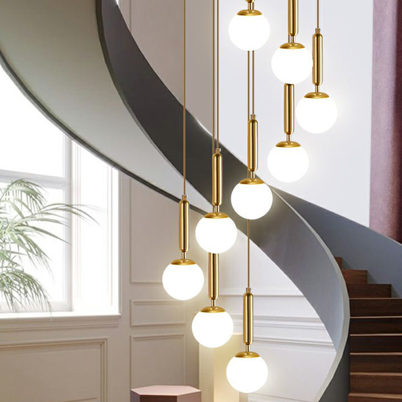 Minimalist Ball Pendant Lighting White Glass Stairway Multi Hanging Light Fixture in Gold 9 Gold Globe Clearhalo 'Art Deco Pendants' 'Cast Iron' 'Ceiling Lights' 'Ceramic' 'Crystal' 'Industrial Pendants' 'Industrial' 'Metal' 'Middle Century Pendants' 'Modern Pendants' 'Modern' 'Pendant Lights' 'Pendants' 'Tiffany' Lighting' 2385128