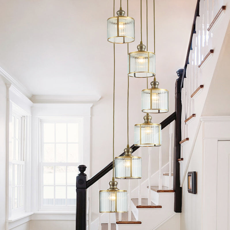Brass Finish Cylinder Multiple Lamp Pendant Postmodern Ribbed Glass Hanging Light Fixture for Stairway 6 Brass Clearhalo 'Ceiling Lights' 'Modern Pendants' 'Modern' 'Pendant Lights' 'Pendants' Lighting' 2461946