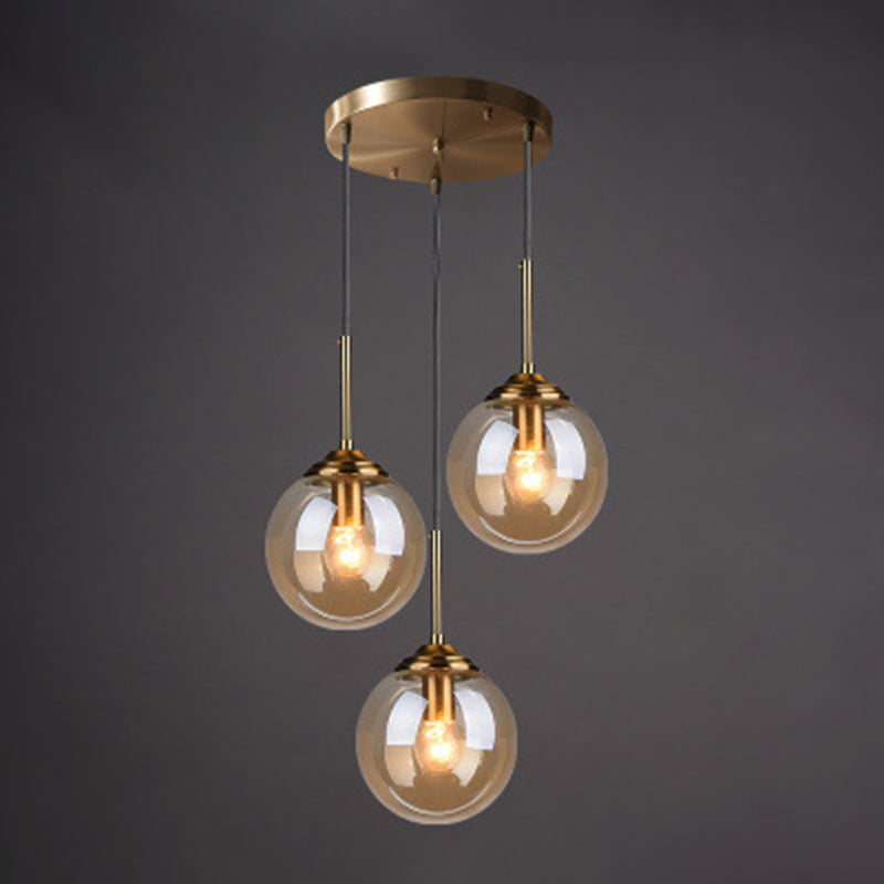 3 Lights Globe Hanging Ceiling Lights Minimalist Glass Multi Light Pendant for Restaurant Amber Round Clearhalo 'Ceiling Lights' 'Pendant Lights' 'Pendants' Lighting' 2630007_076ca00b-5228-44d3-9ba2-f9314f36b1d7