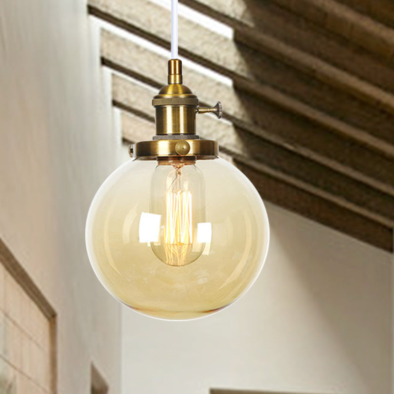 Orbit Hanging Lighting Farmhouse Amber/Clear Glass 1 Bulb Pendant Light Fixture with Adjustable Cord in Black/Bronze/Brass Finish Brass Amber Clearhalo 'Art Deco Pendants' 'Black' 'Cast Iron' 'Ceiling Lights' 'Ceramic' 'Crystal' 'Industrial Pendants' 'Industrial' 'Metal' 'Middle Century Pendants' 'Pendant Lights' 'Pendants' 'Rustic Pendants' 'Tiffany' Lighting' 273917