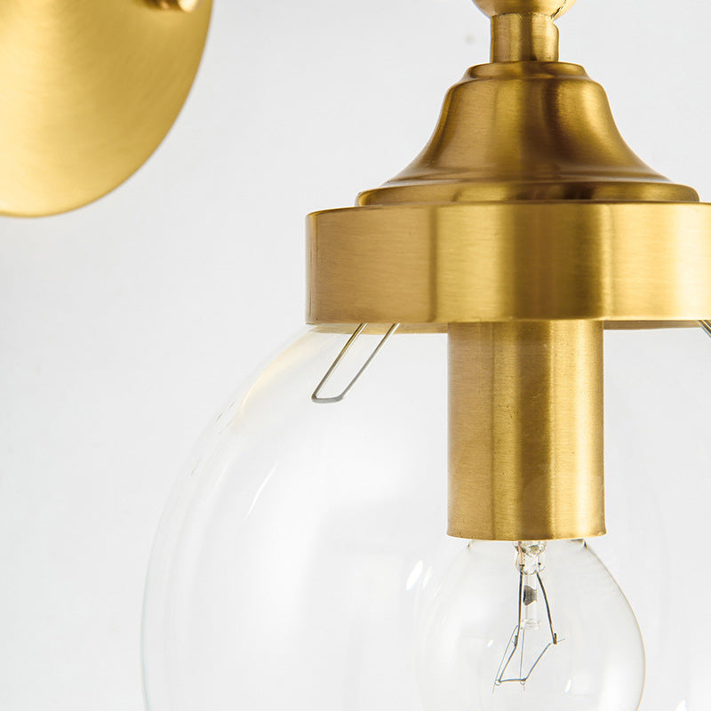 Adjustable Globe Sconce Light Simplicity 1 Bulb Brass Wall Mount Lamp with Transparent Glass Shade Clearhalo 'Cast Iron' 'Glass' 'Industrial' 'Modern wall lights' 'Modern' 'Tiffany' 'Traditional wall lights' 'Wall Lamps & Sconces' 'Wall Lights' Lighting' 275016