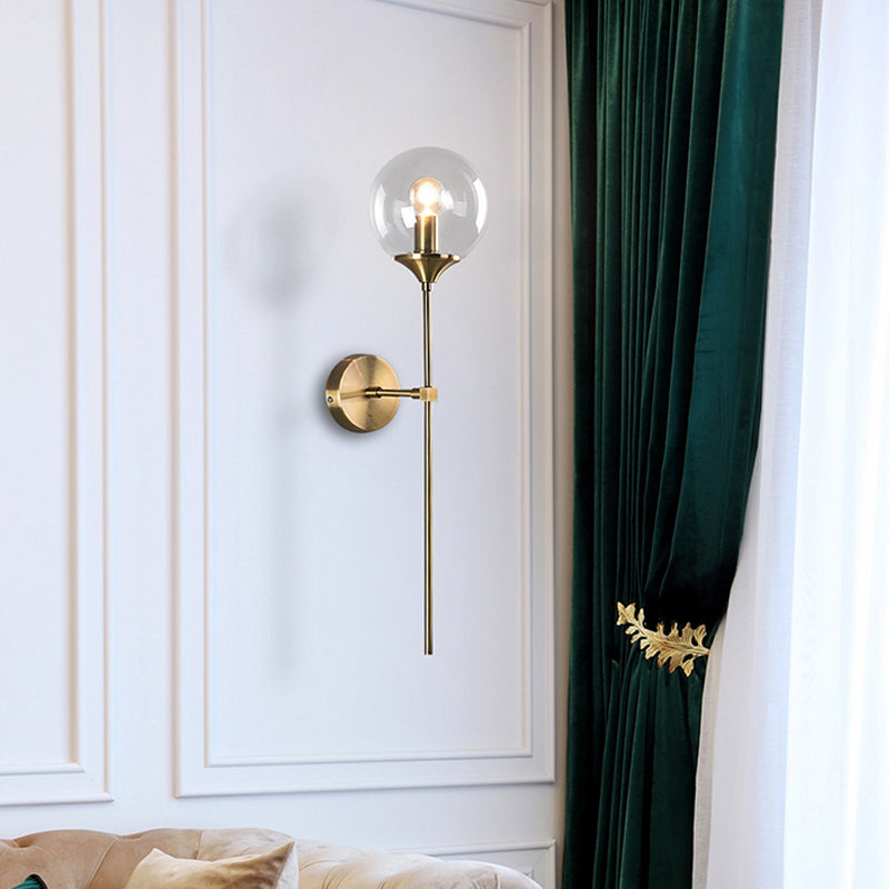 Modernist Round Wall Lamp Clear/Amber/Smoke Gray Glass 1 Bulb Bedside Sconce Light Fixture with Metal Pencil Arm Clearhalo 'Cast Iron' 'Glass' 'Industrial' 'Modern wall lights' 'Modern' 'Tiffany' 'Traditional wall lights' 'Wall Lamps & Sconces' 'Wall Lights' Lighting' 325684