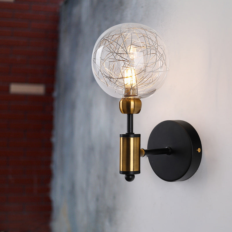 1/2-Light Bedroom Sconce Wall Light Industrial Style Black/Brass Finish Wall Lamp with Orbit Clear Glass Shade Clearhalo 'Art deco wall lights' 'Cast Iron' 'Glass' 'Industrial wall lights' 'Industrial' 'Middle century wall lights' 'Modern' 'Rustic wall lights' 'Tiffany' 'Traditional wall lights' 'Wall Lamps & Sconces' 'Wall Lights' Lighting' 331671