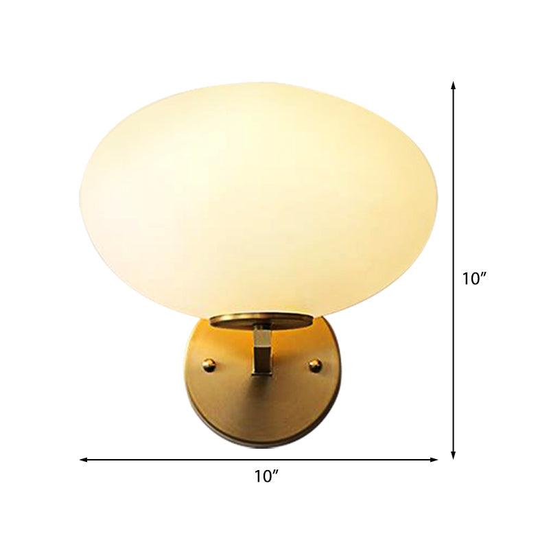 Milk Glass Oval Wall Mount Lamp Modern 1 Light Bedside Wall Sconce Light in Brass Clearhalo 'Cast Iron' 'Glass' 'Industrial' 'Modern wall lights' 'Modern' 'Tiffany' 'Traditional wall lights' 'Vanity Lights' 'Wall Lights' Lighting' 370187
