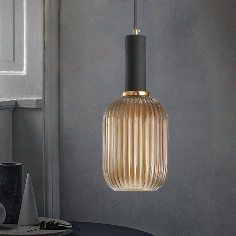 Black/Gold Cylinder/Oval/Capsule Pendant Lamp Modernist 1 Light Grey/Green/Amber Ribbed Glass Ceiling Light Fixture for Kitchen Black Amber Capsule Clearhalo 'Ceiling Lights' 'Glass shade' 'Glass' 'Modern Pendants' 'Modern' 'Pendant Lights' 'Pendants' Lighting' 598310