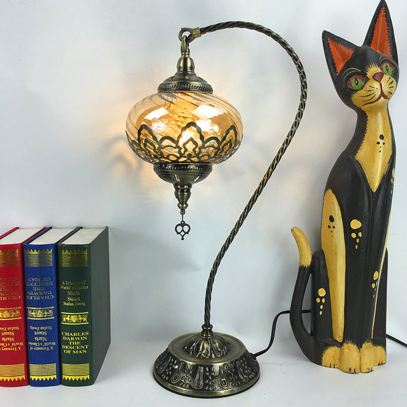 Brass/Gloss Black 1 Head Table Lamp Bohemia Amber Glass Oval/Urn Nightstand Lighting with Curved Arm Clearhalo 'Lamps' 'Table Lamps' Lighting' 920934